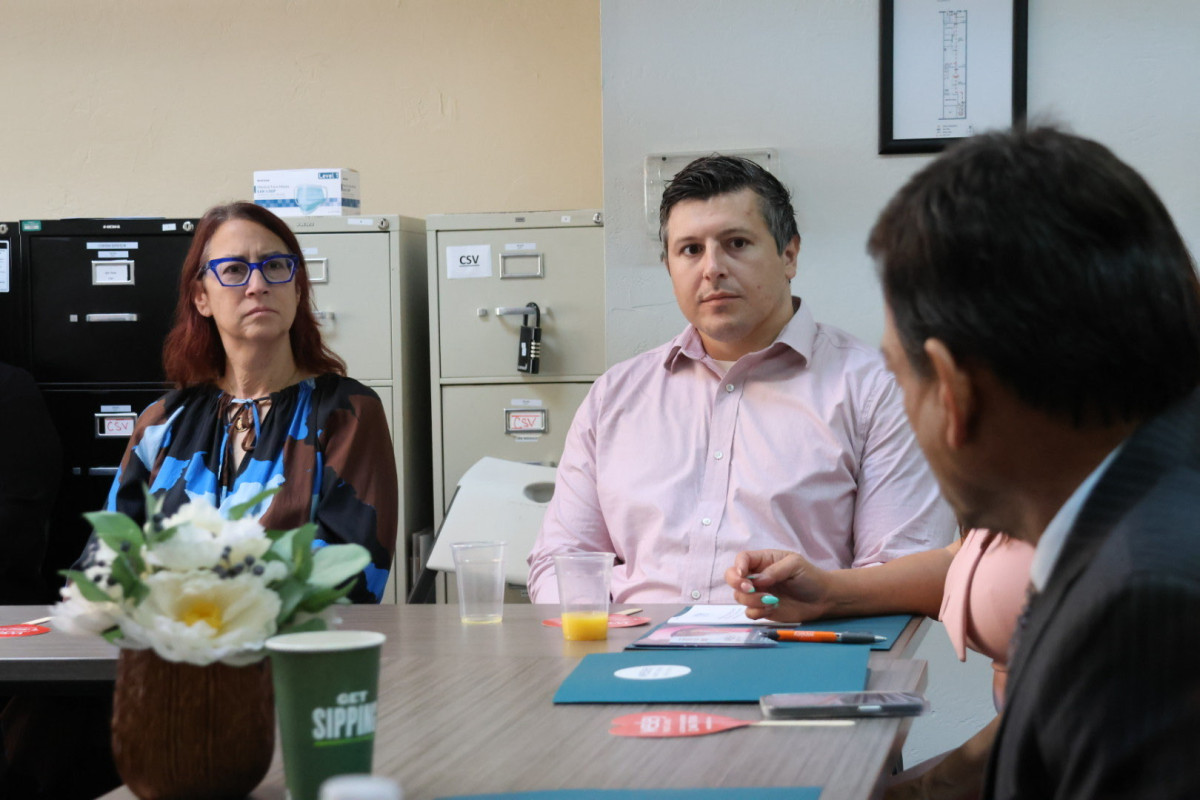 Friedman listens to a presentation from Al Ballesteros, CEO of Wesley Health Center.