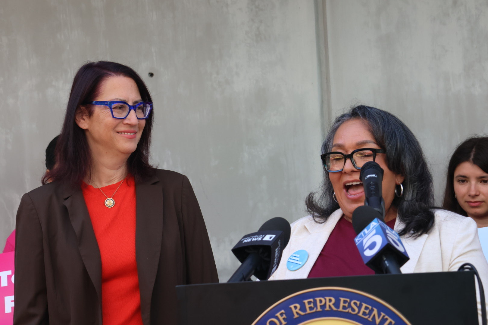 Claudia Estrada Powell of Planned Parenthood LA speaking at the podium.