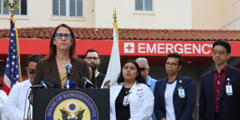 Above: Friedman standing with frontline healthcare workers and patients.