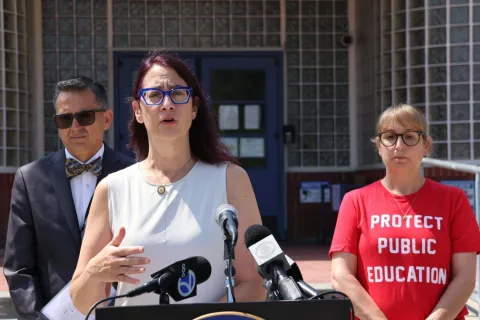 Below: Friedman with school administrators, educators, and parents.