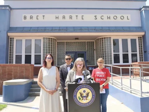 Below: Friedman with school administrators, educators, and parents.