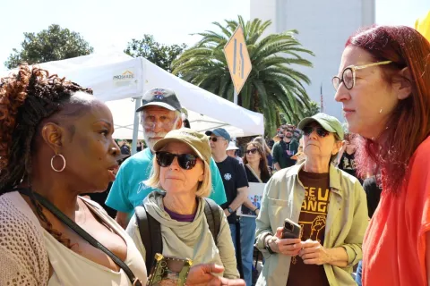 Below: Friedman speaks with constituents after concluding her speech.