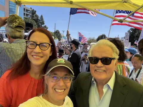 Below: Friedman takes a picture with fellow Democrat and actor Martin Sheen and an organizer with Grassroots Democrats.