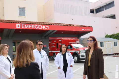 Below: Friedman standing with frontline healthcare workers and patients.
