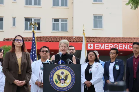 Below: Friedman standing with frontline healthcare workers and patients.